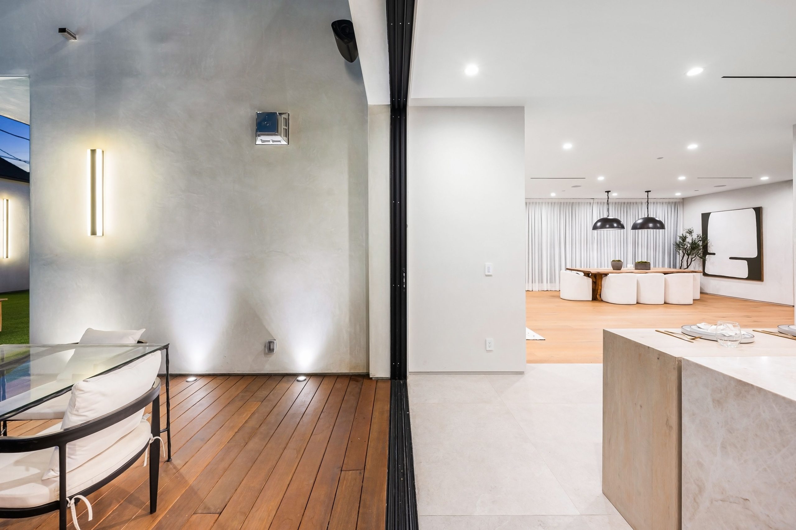 Modern house with wooden facade at sunset Modern two-story house with a wooden facade illuminated by the sunset